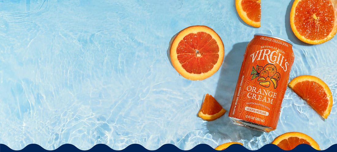 Virgil's Orange Cream soda can with orange slices on a blue water background